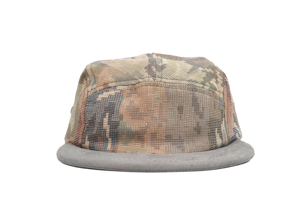 A camouflage five panel hat with a gray mesh back and flat gray brim, shown against a plain white background.