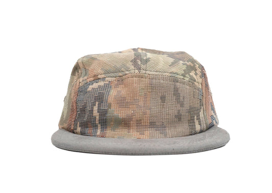 A camouflage five panel hat with a gray mesh back and flat gray brim, shown against a plain white background.