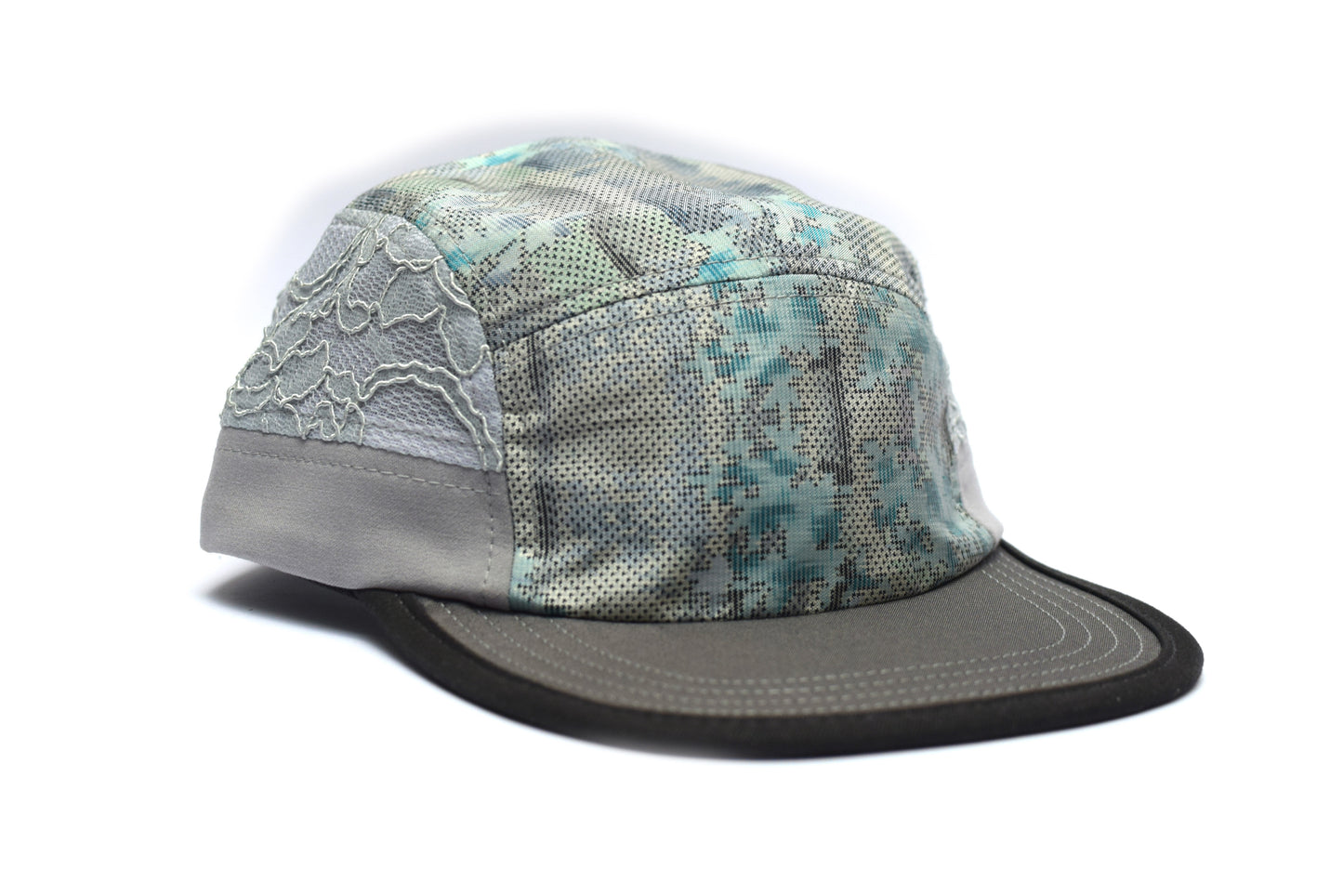 Camouflage-patterned cap with gray brim on a white background