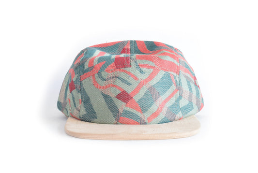Colorful patterned five panel hat on a beige background