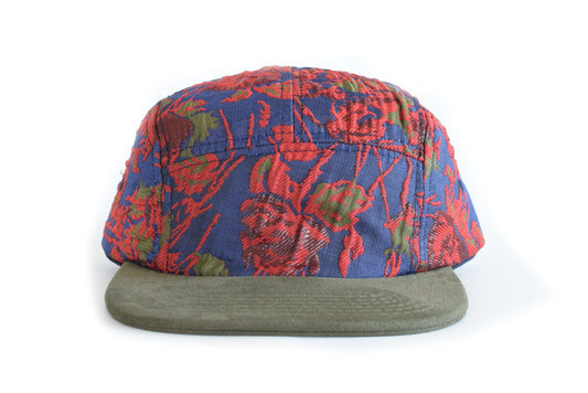 Colorful patterned cap with a green brim on a white background