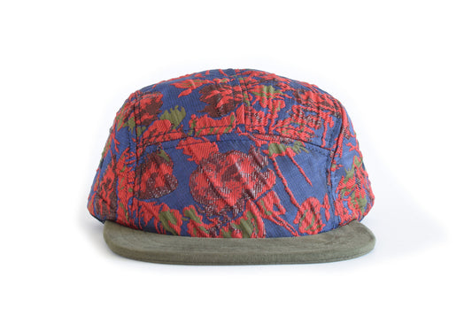Colorful patterned cap with a green base on a white background